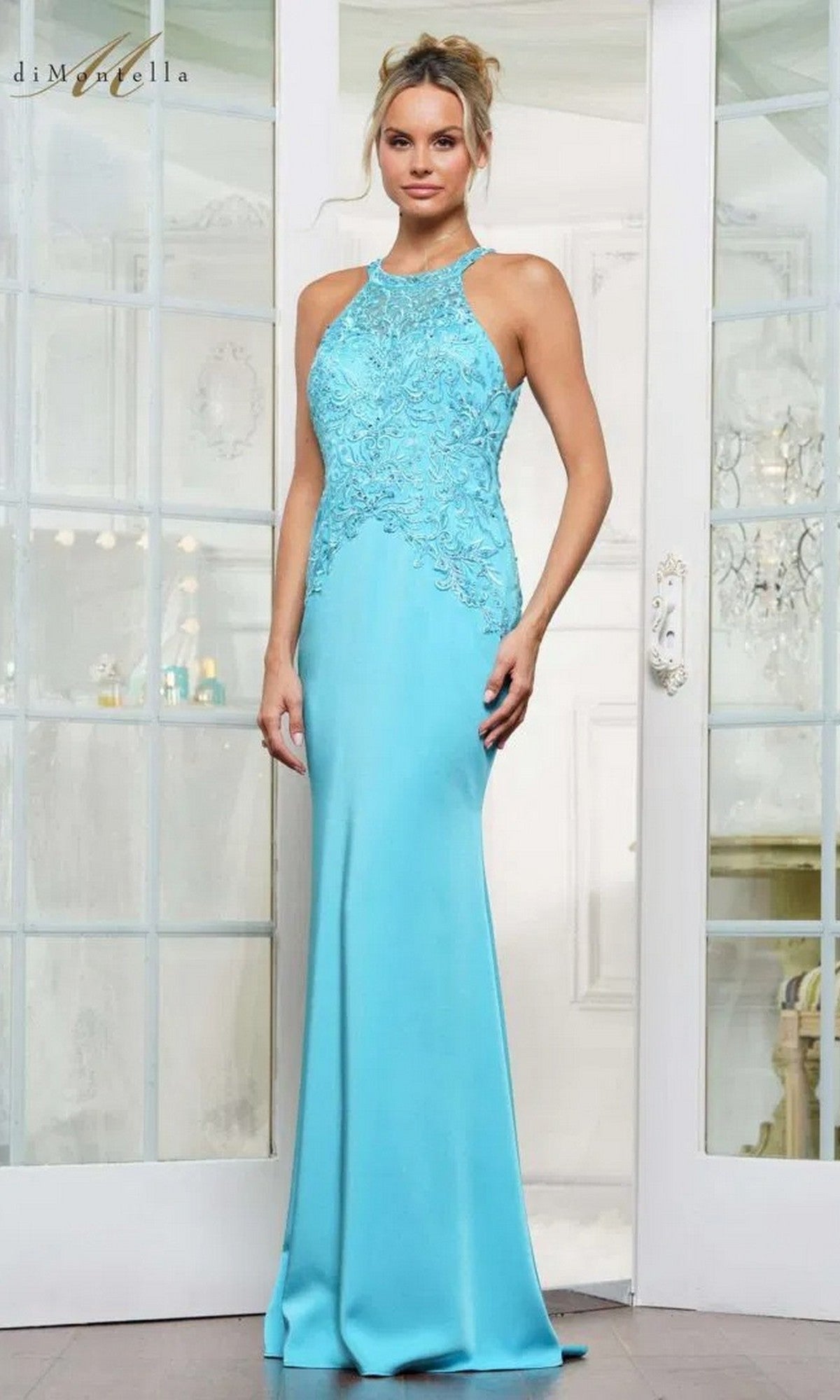 A woman stands indoors wearing the Long Formal Dress: Rina Di Montella RD2755, a light blue, floor-length gown with a sleeveless design, embroidered bodice, and delicate lace detailing.
